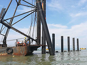 Barge in Malaysia assisting with pile installation