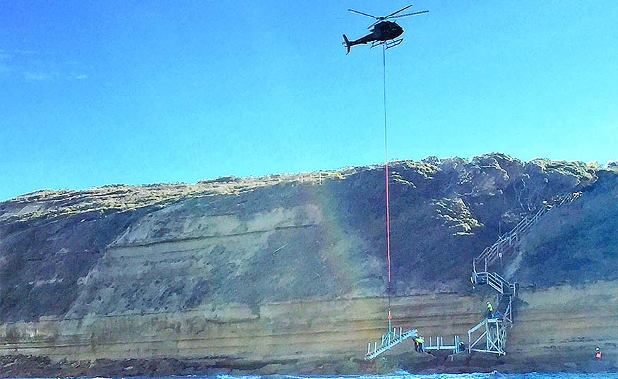 Helicopter lowering beach access steps at Jan Juc beach surf access point