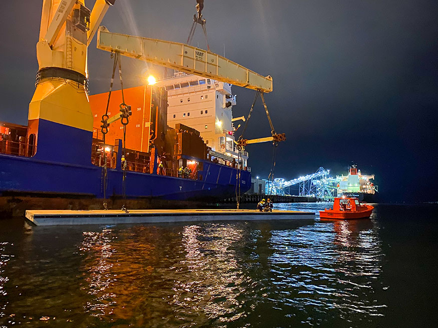 Wave attenuator and workers at night